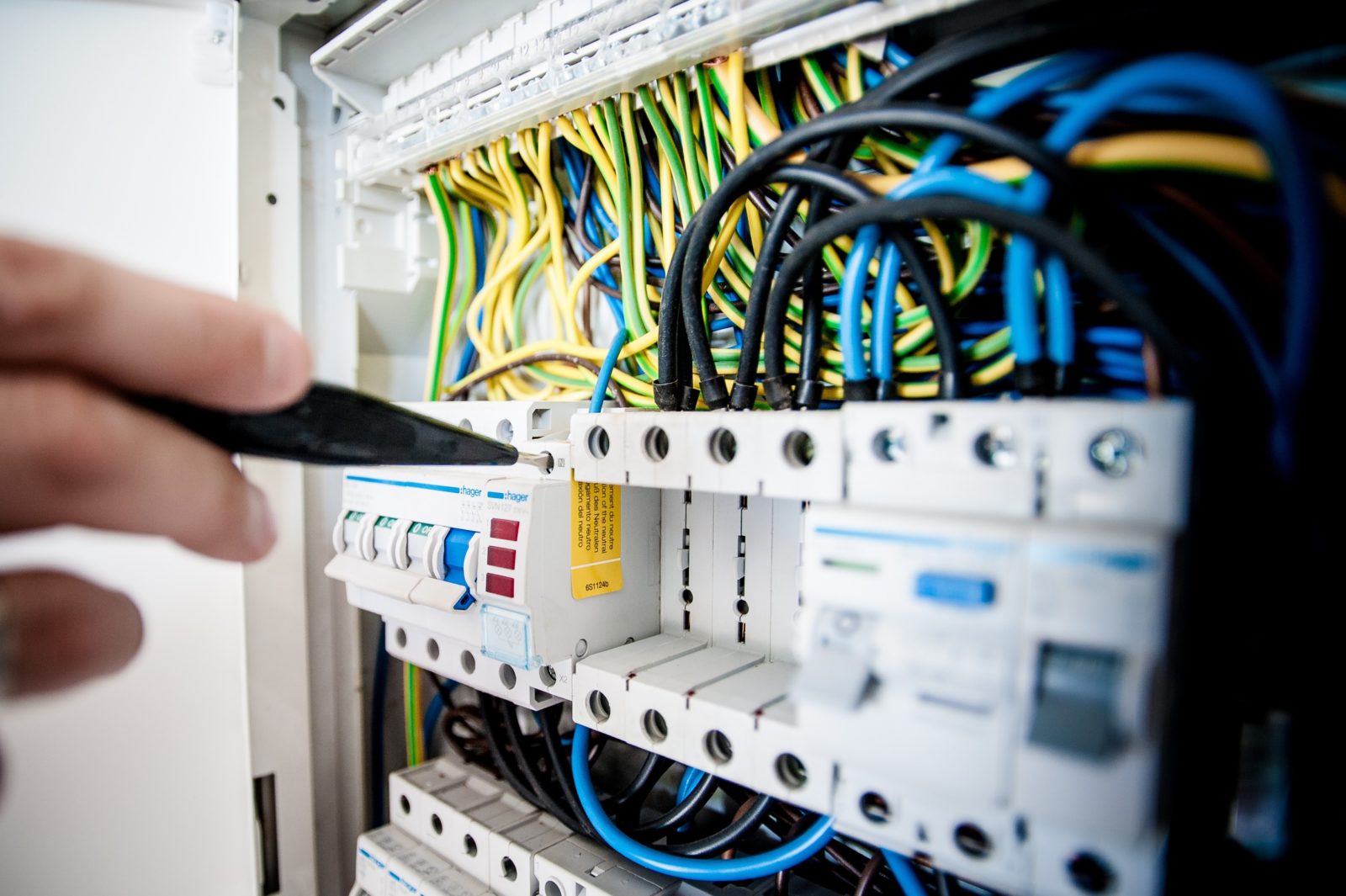 Close-up of a hand handling electrical wires during installation